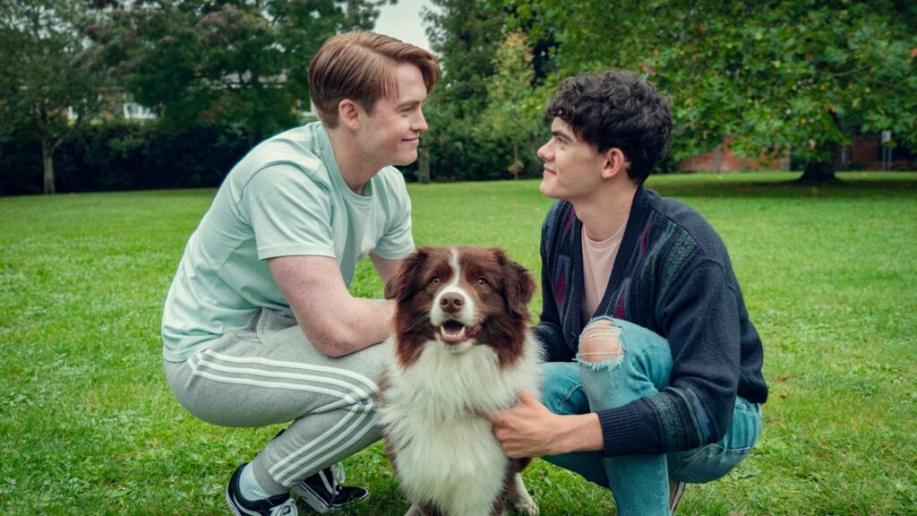 The actors Kit Connor, Joe Locke and a dog in a still from the TV show Heartstopper