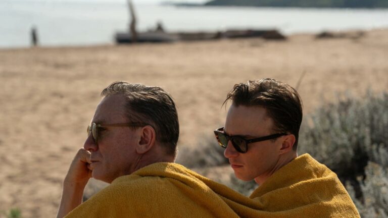 Daniel Craig and Drew Starkey wrapped in a yellow towel