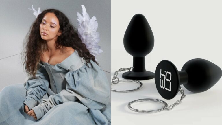 Jade Thirlwall sitting in a denim dress with angel wings and a butt plug key chain