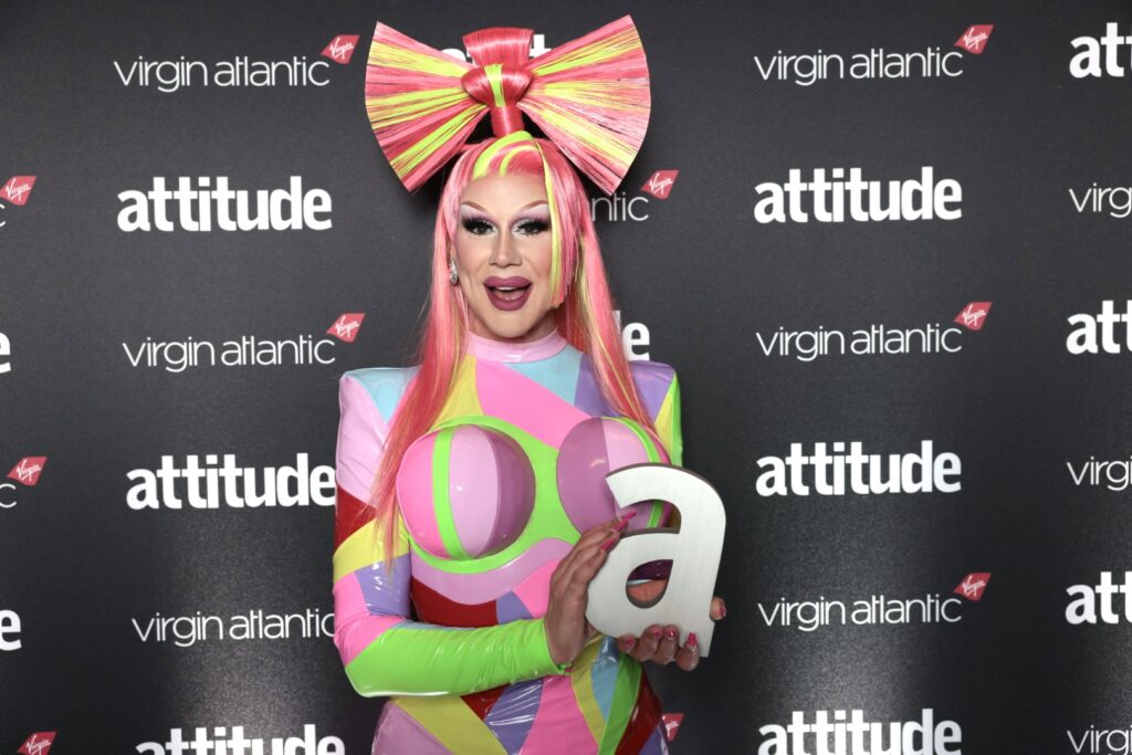 Jimbo in a multi-coloured dress holding her Attitude Award