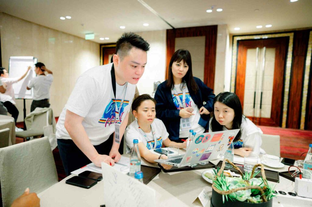 A group of people looking at a laptop screen