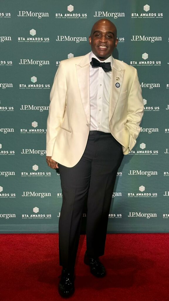 A man in a white dinner jacket on a red carpet