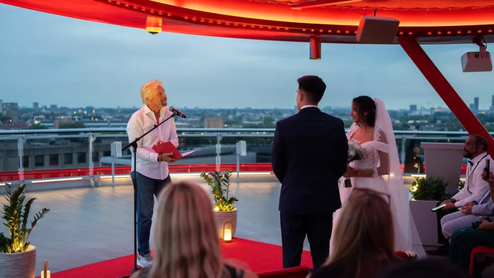 Richard Branson officiating a wedding on board a Virgin Voyages cruise ship