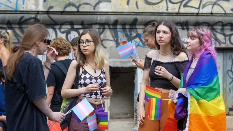 Four LGBTQ Pride attendees, posed by models