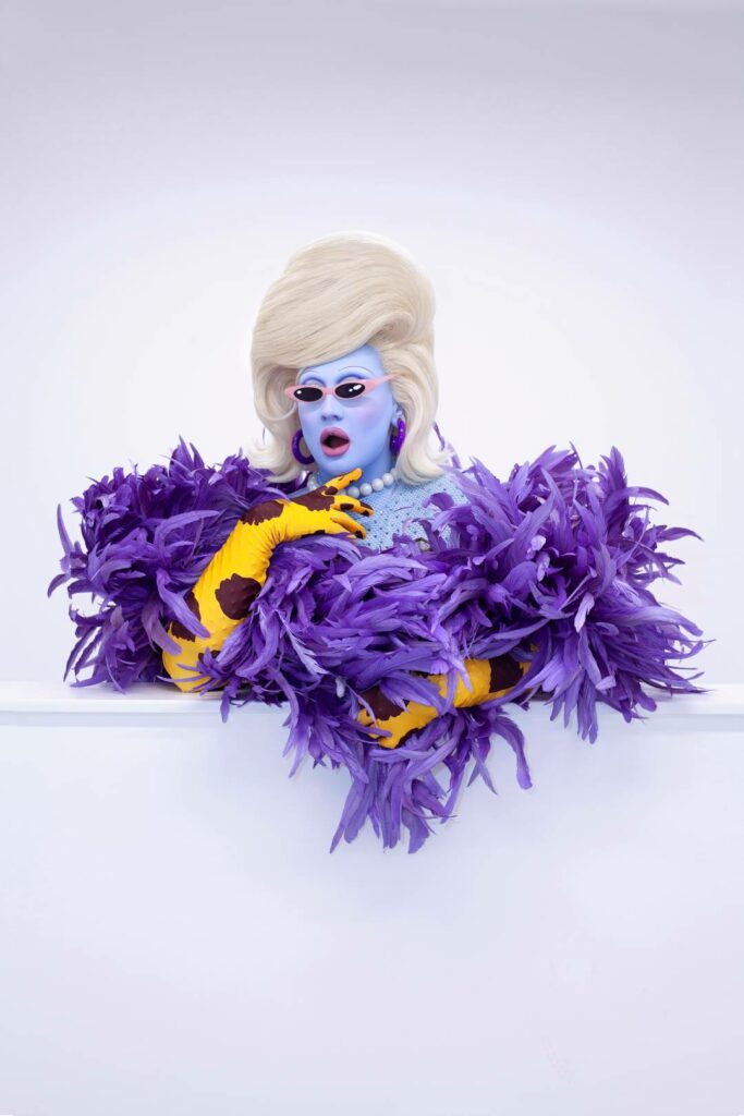 Juno Birch wearing a purple feathery dress