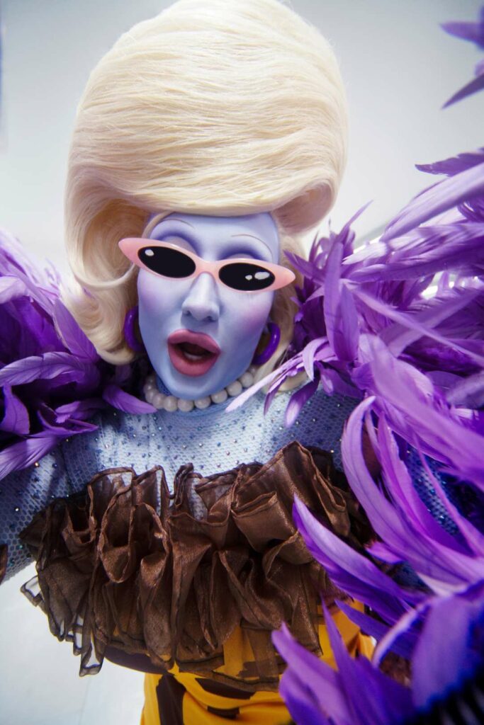 Juno Birch wearing a purple feathery dress