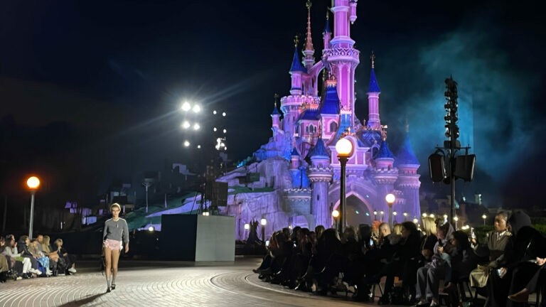 A model walks a runway outside at Disneyland Paris