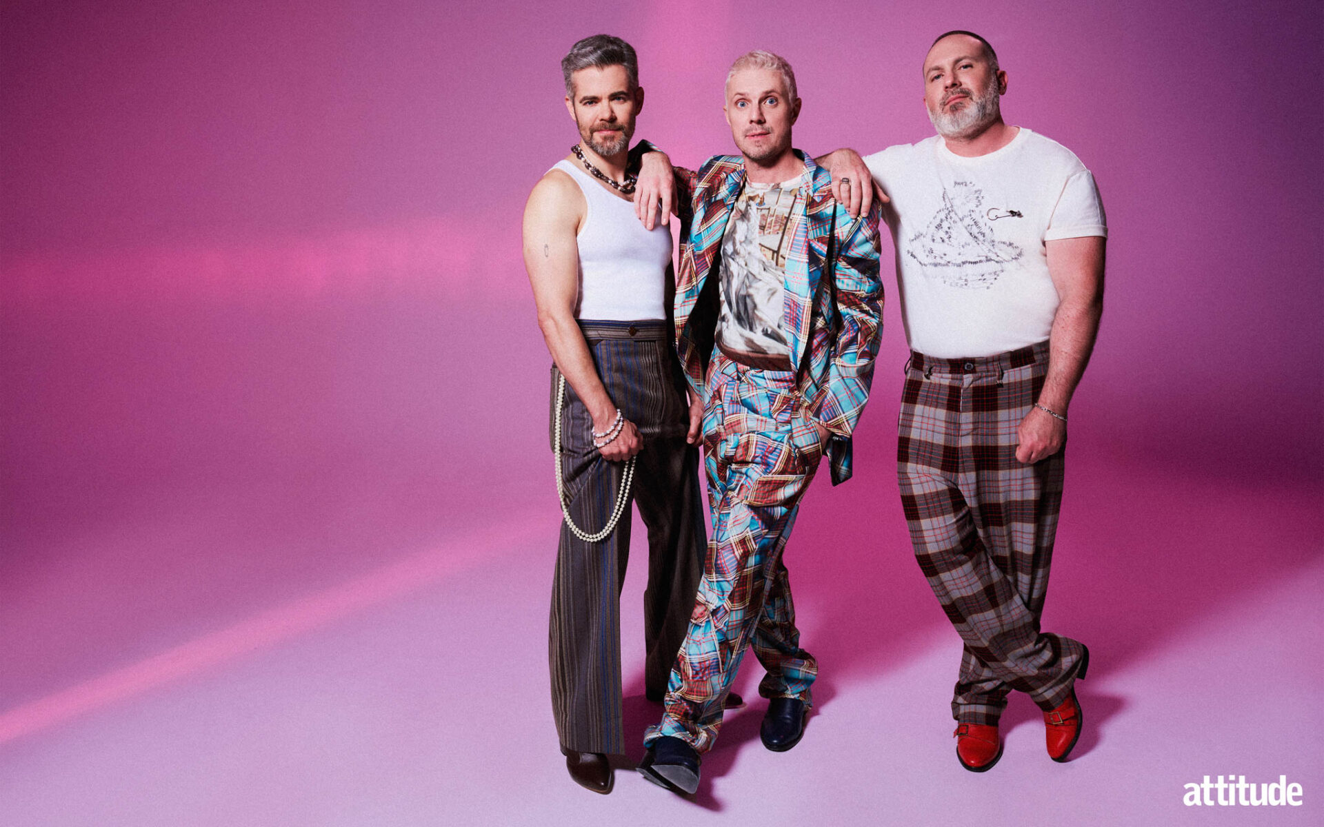 Del Marquis, Jake Shears and Babydaddy from Scissor Sisters; Del in a white vest, Jake in a patterned suit and Babydaddy in a white t-shirt and tartan trousers