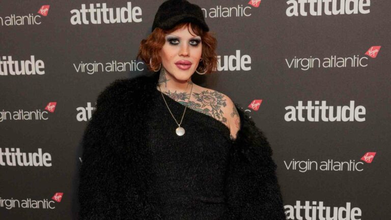 Lill standing on the red carpet at the Attitude Awards