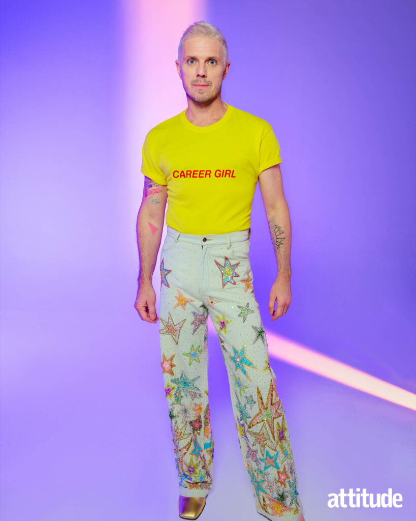 Jake in a yellow t-shirt with the slogan 'career girl' and jeans with stars embroidered on them