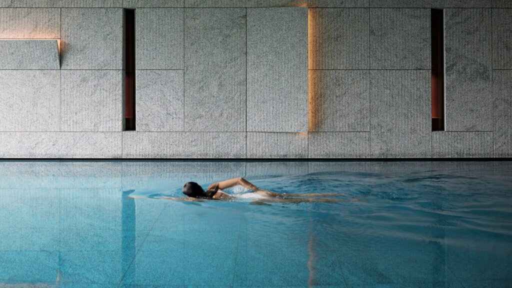 Large swimming pool with lady swimming 