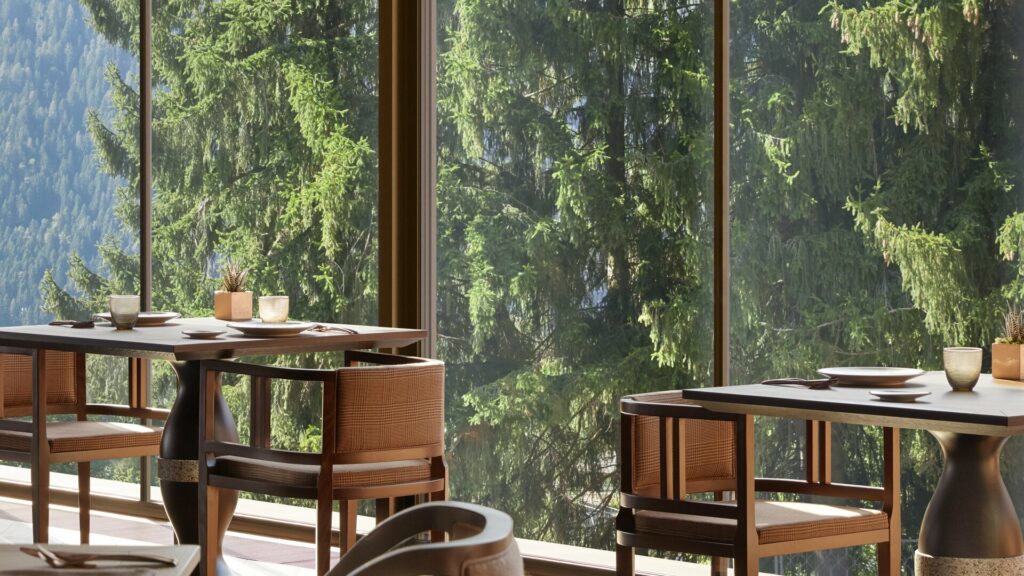 Gastro style restaurant, with table and chairs facing mountains 