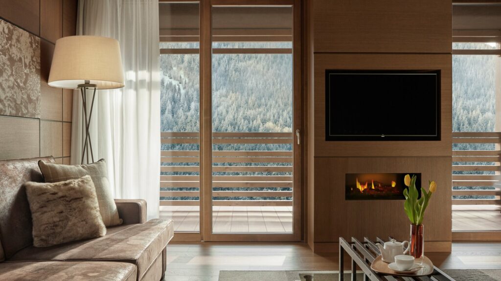 Bedroom with TV & fireplace and view of mountains 