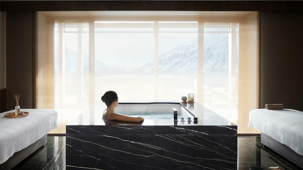 Large marble bathtub with view of mountains 