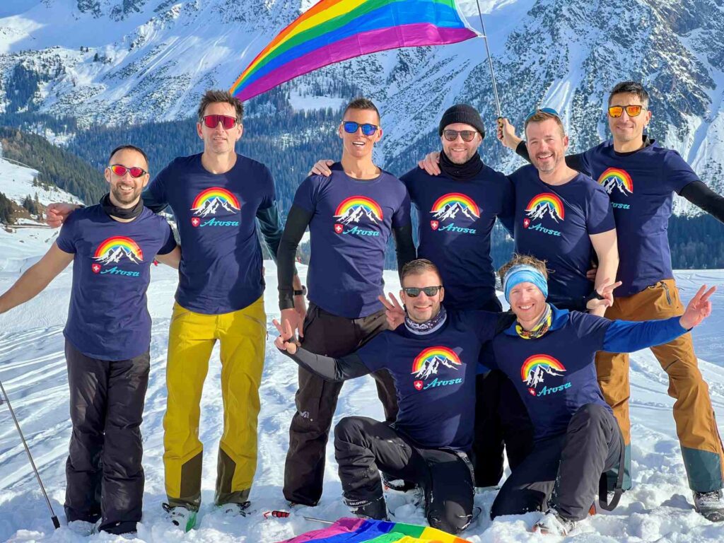 A group of men standing on a ski slope