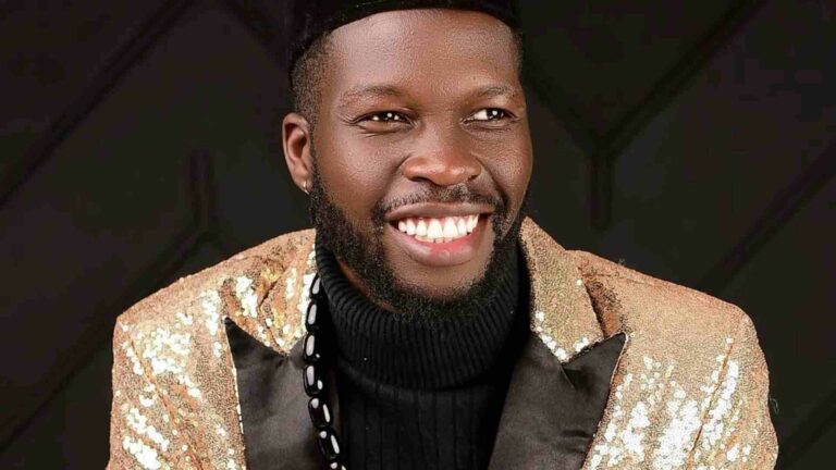 A smiling man in a gold jacket