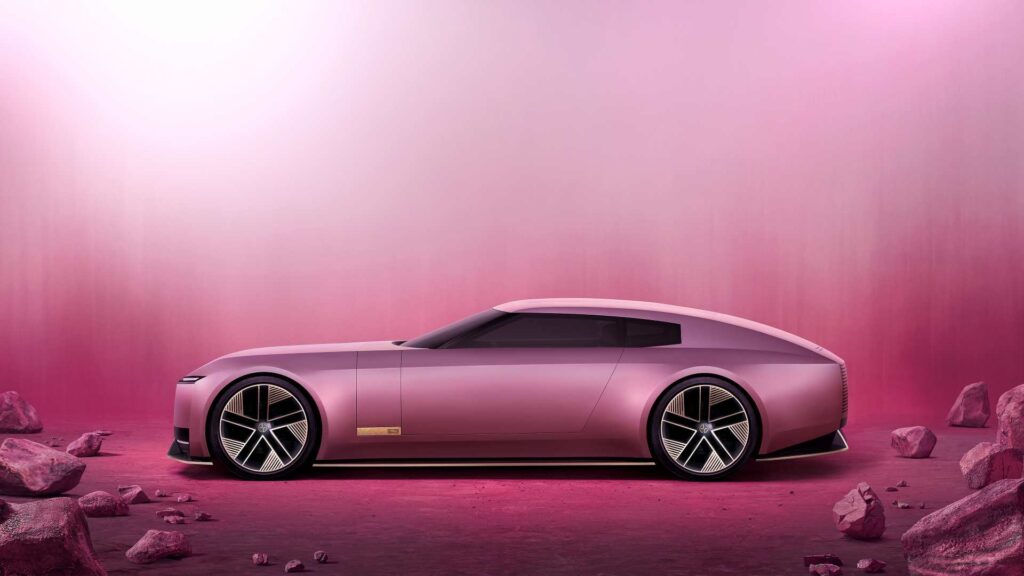 A pink Jaguar Type 00 car against a pink backdrop