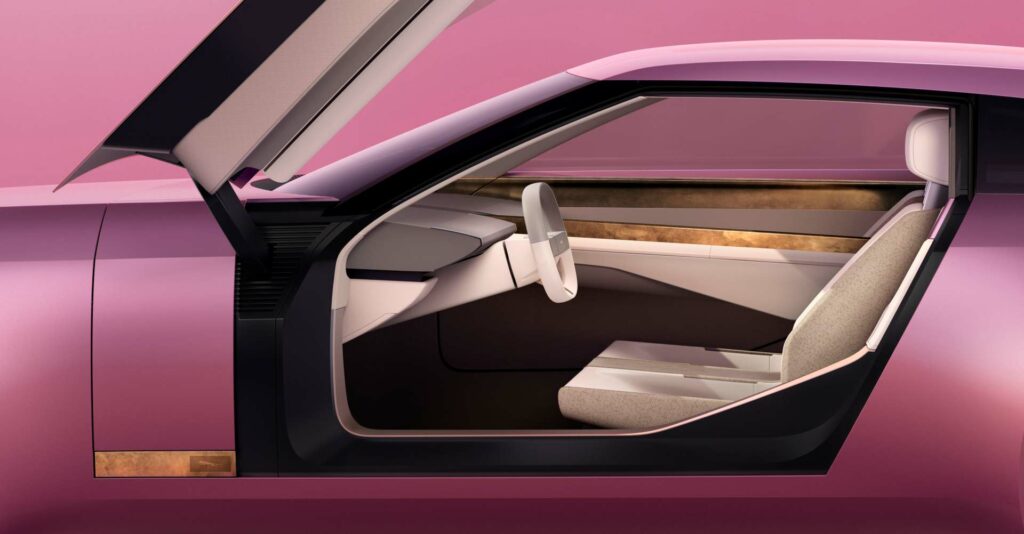 Interior of a pink Jaguar Type 00 car against a pink backdrop