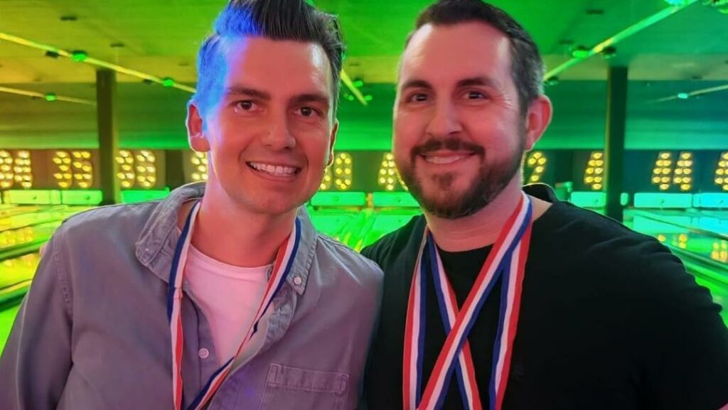 Two smiling men wearing medals