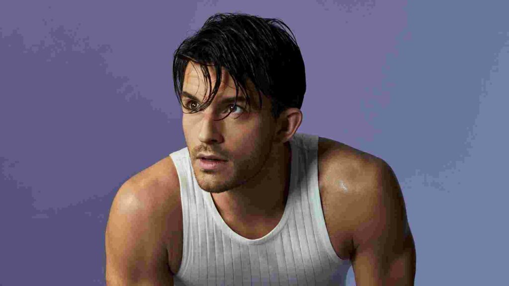 Jonathan Bailey in a white vest.