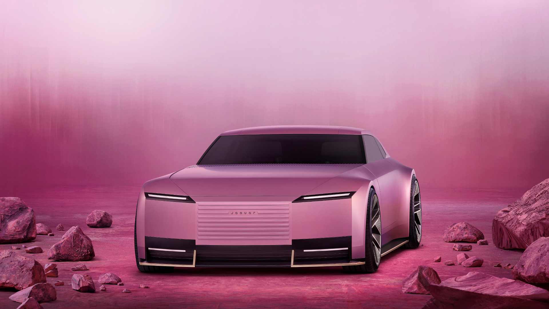 A pink Jaguar Type 00 car against a pink backdrop