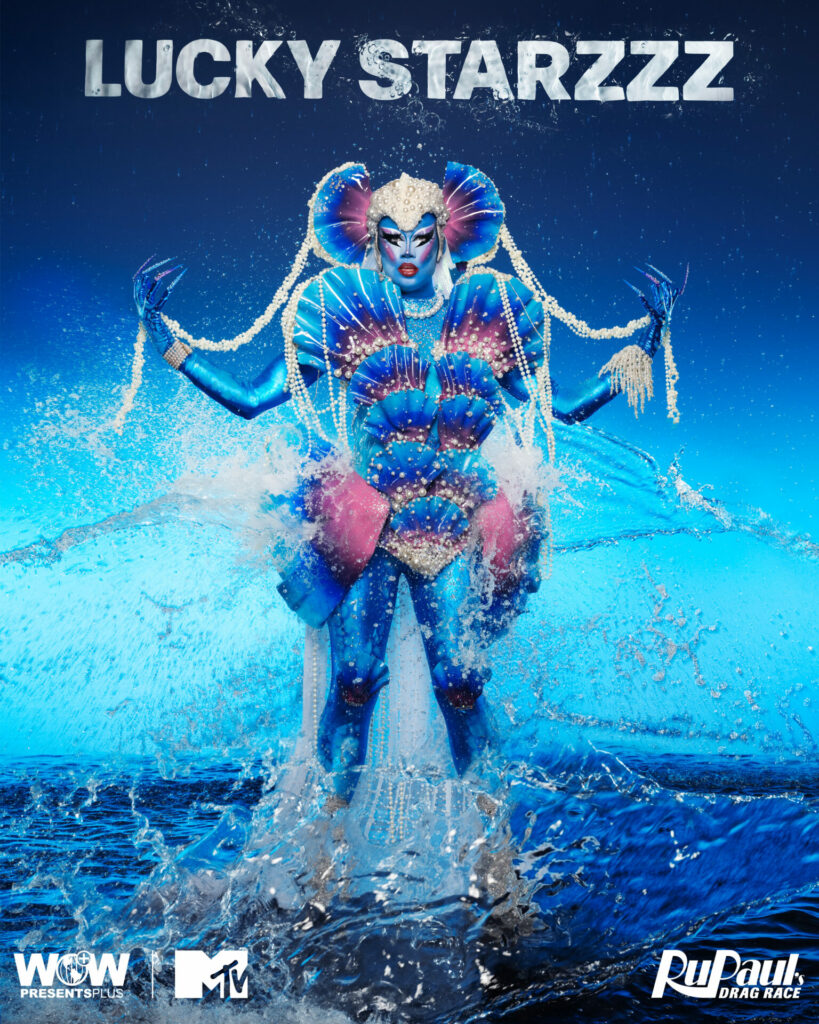 A drag queen against a water-themed blue backdrop