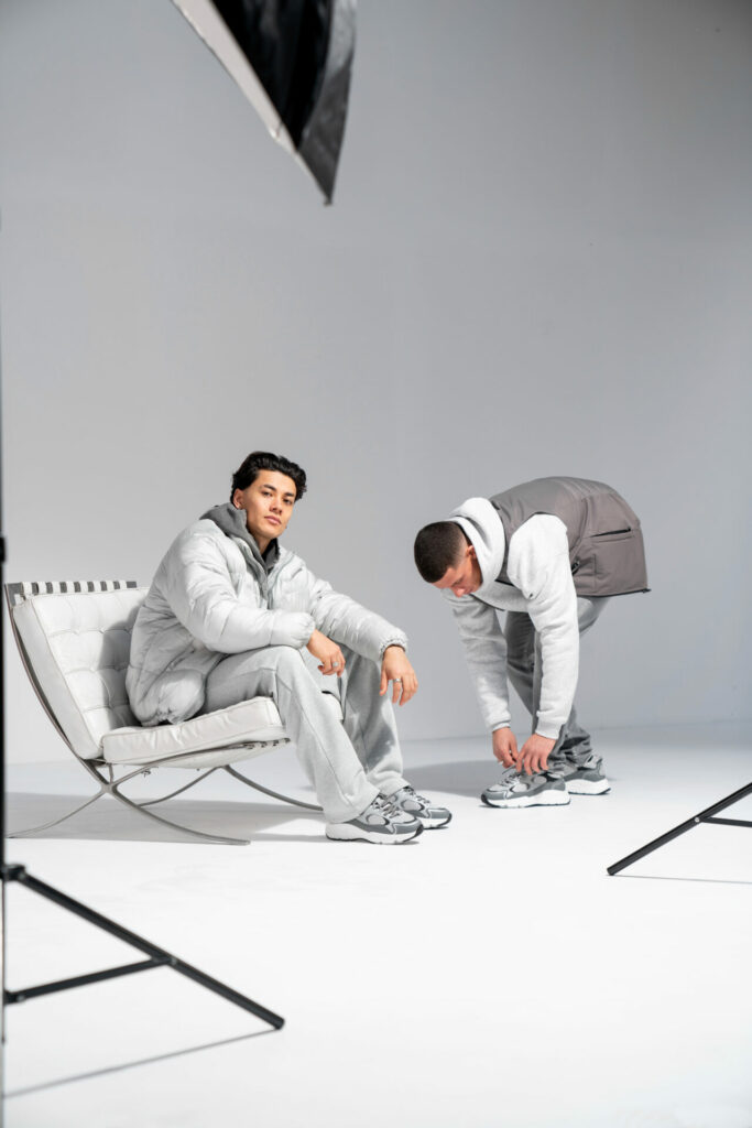 Two models are posing wearing grey tracksuits and Cleens grey trainers