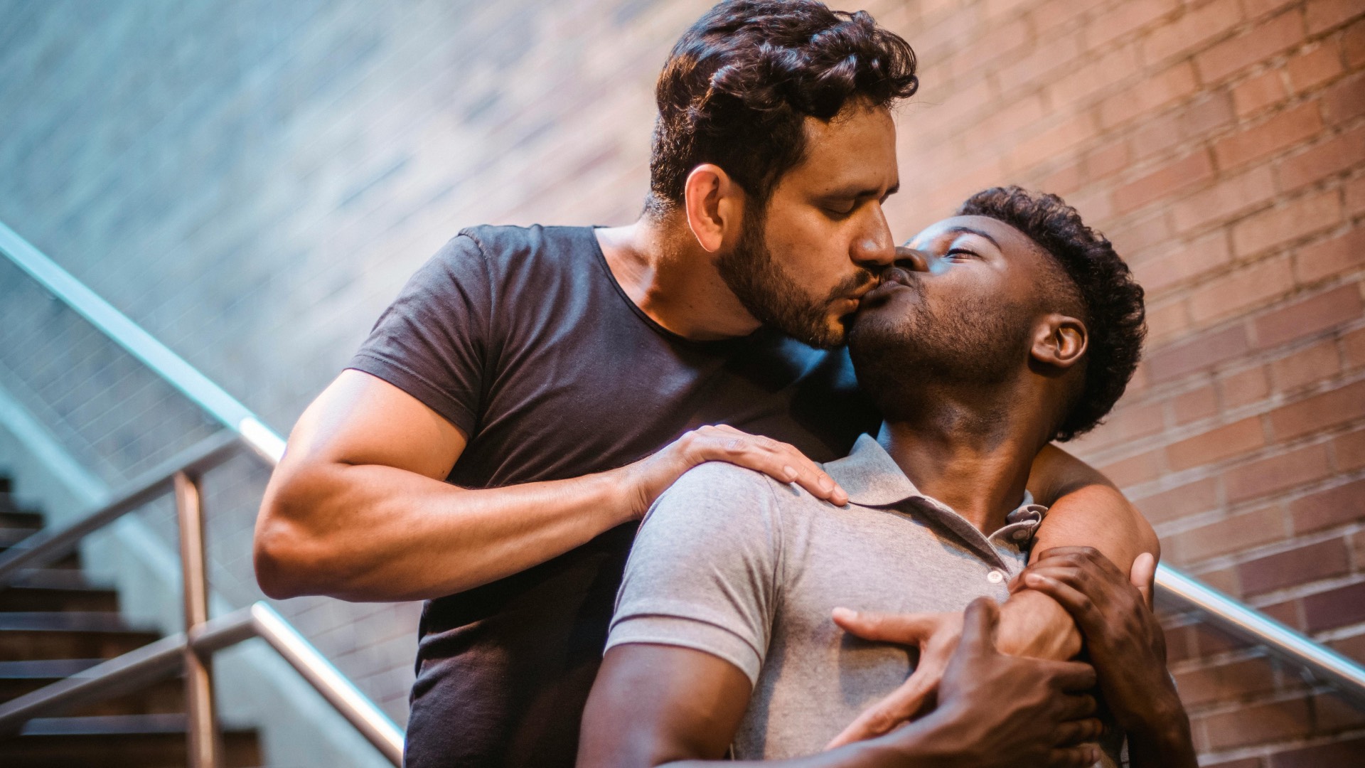 two men kissing; posed by models