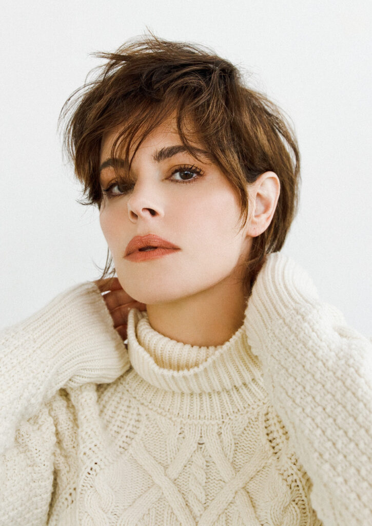 Emily Hampshire in a white sweater