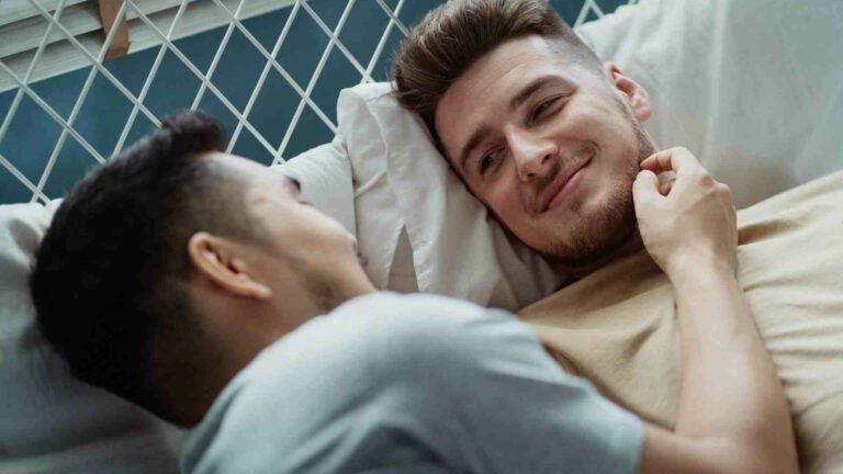 Two men in a bed embracing