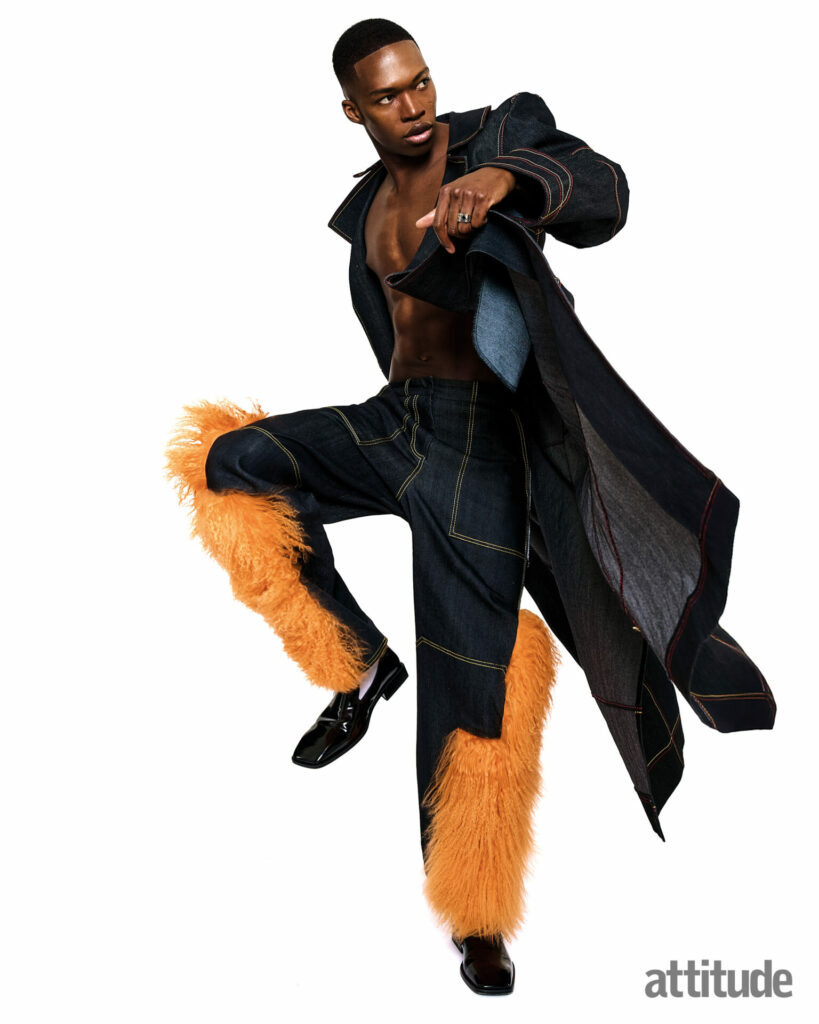 Model poses in double denim set with orange fur trim on the trousers