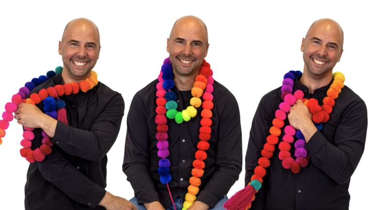 Composite of a man wearing Pride decorations smiling