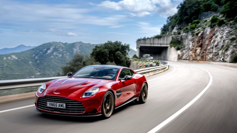 a shot of the car on a road in a mountain range