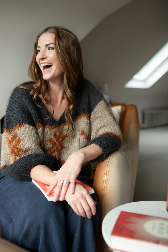 A smiling woman in a knitted top