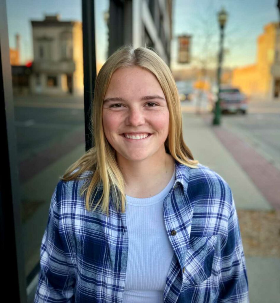 A smiling woman with blond hair