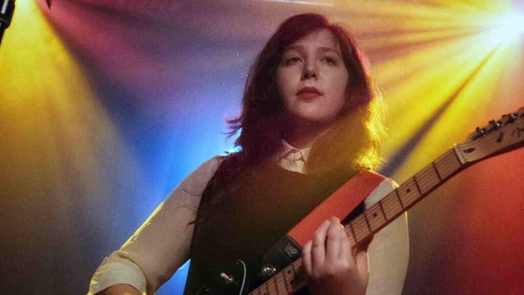 Lucy Dacus holding a guitar