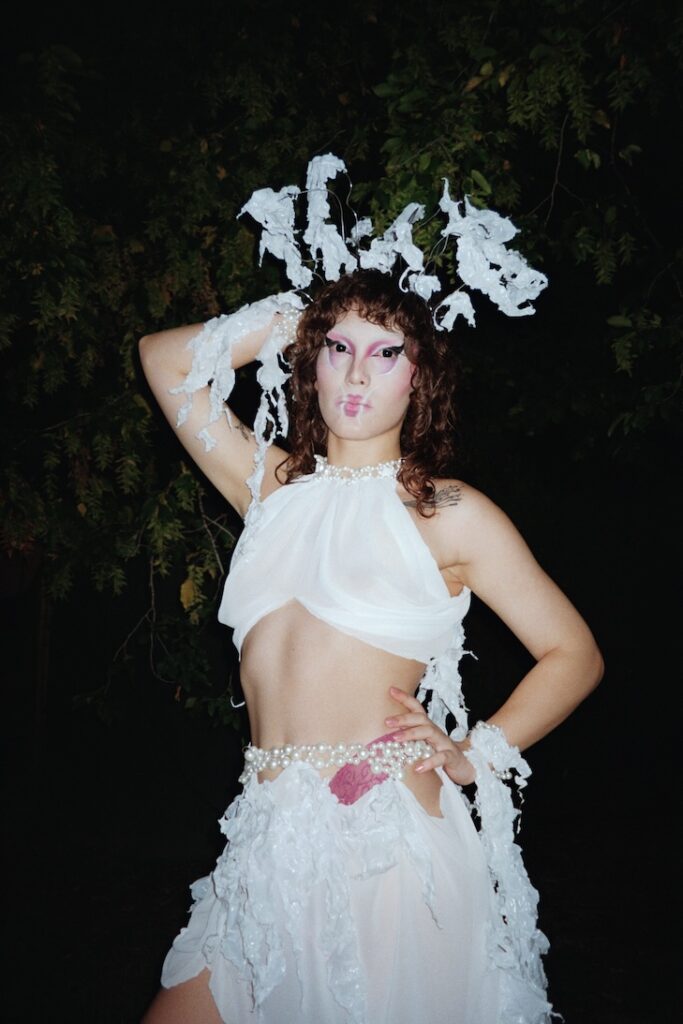 a queer party-goer in a white dress