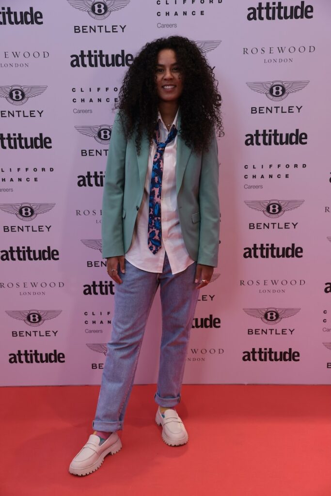 char Bailey in shirt, tie, jeans, and blazer