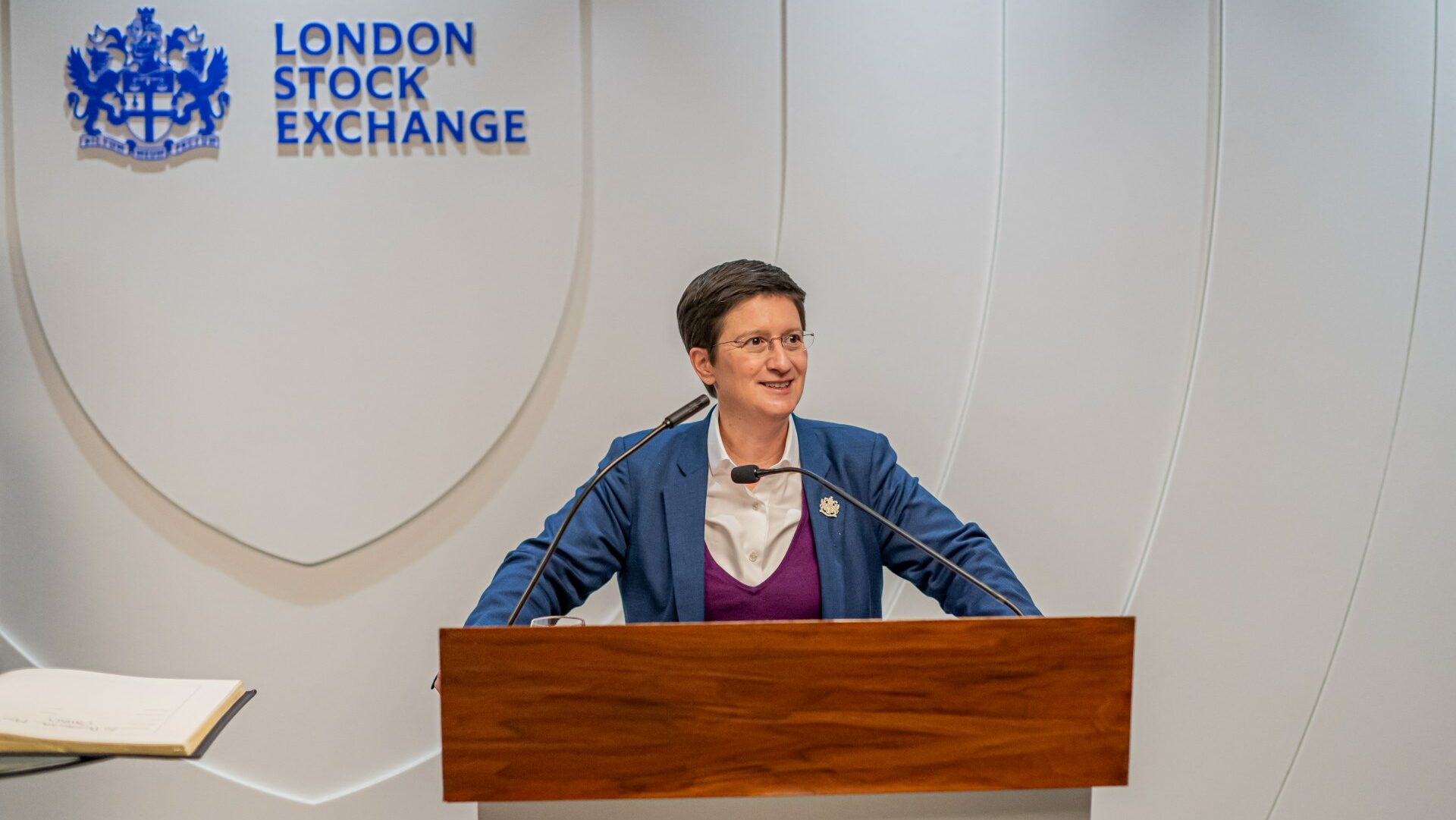 Julia Hoggett speaking at a podium