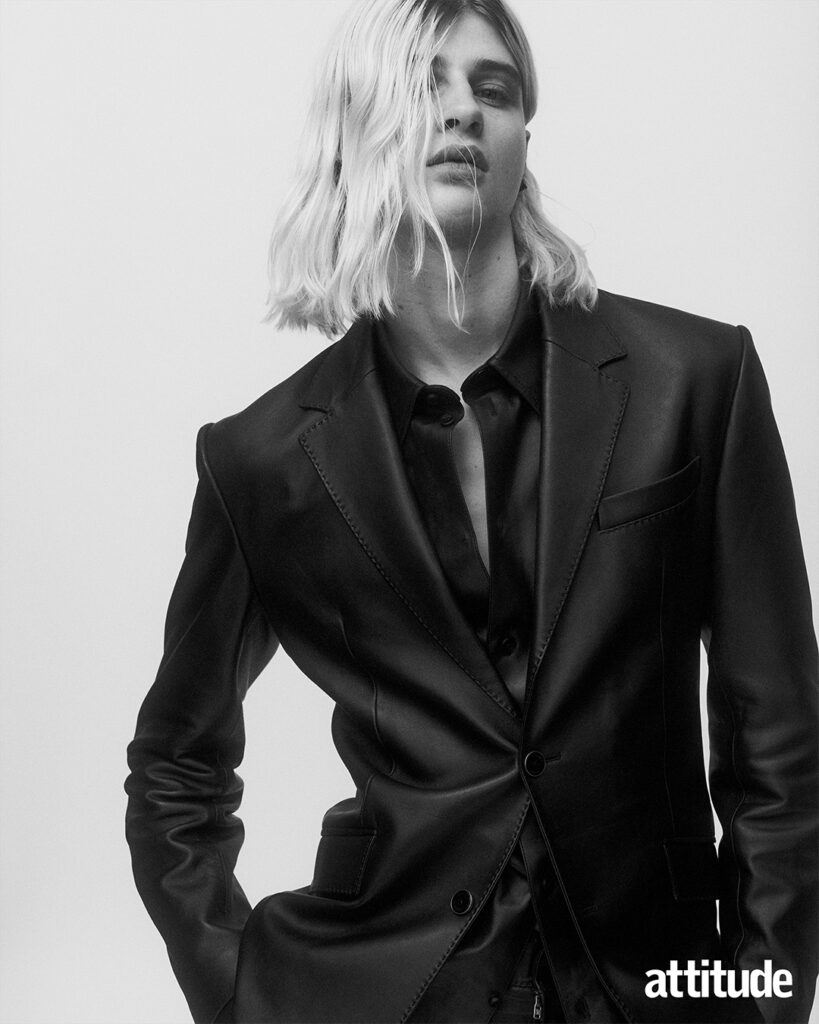 Close up shot of model in black fitted suit and black shirt