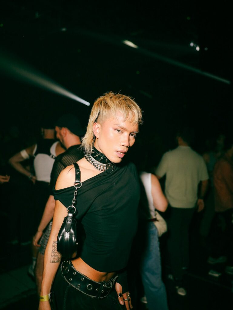 a club-goer in a black top and blonde hair