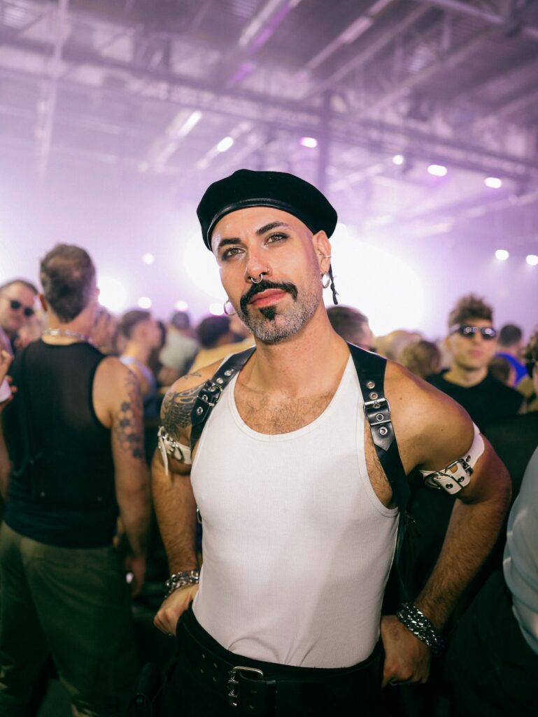 a club-goer in a white vest and beret