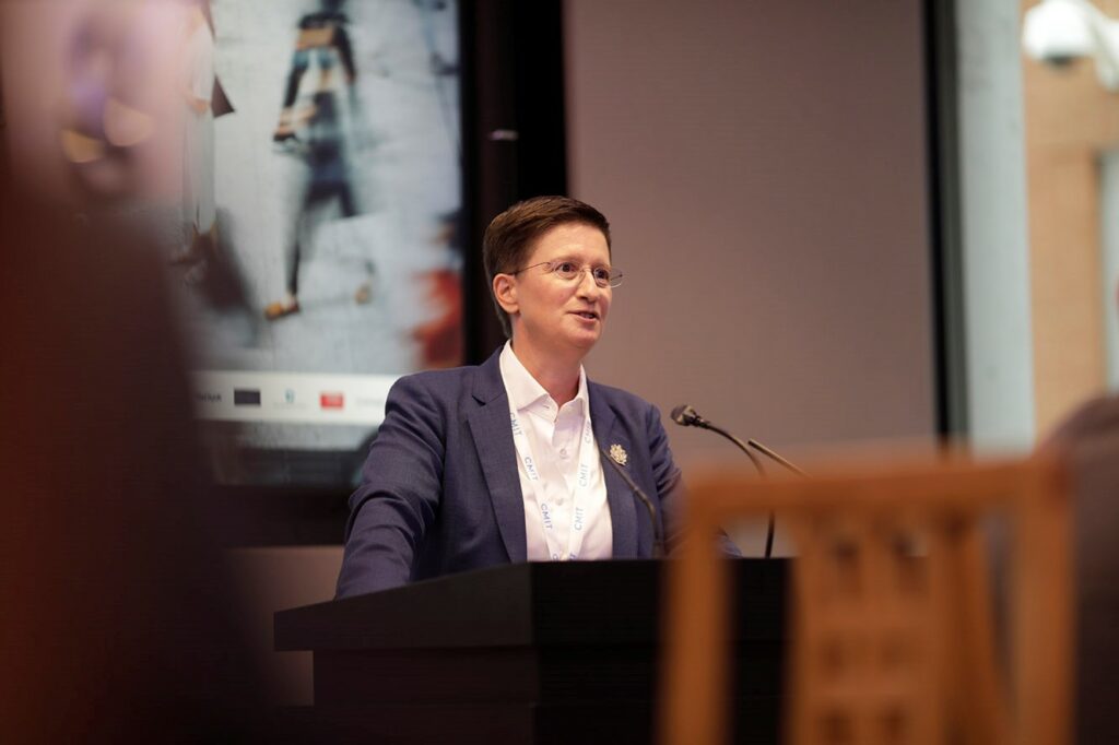 Julia Hoggett giving a speech at a podium