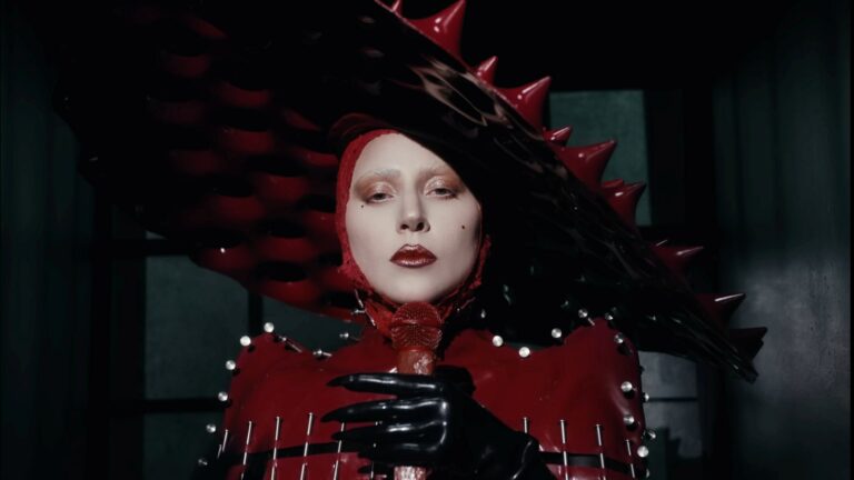 Lady Gaga in a red latex dress and hat