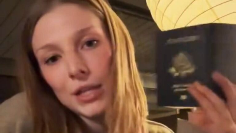 Hunter Schafer holding her passport