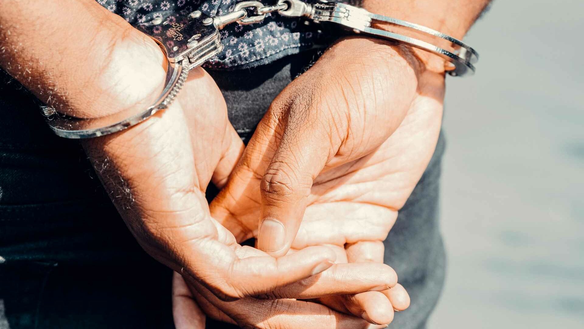 Close up of a person's hands in handcuffs