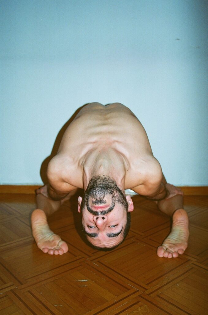 a man kneeling over backwards 