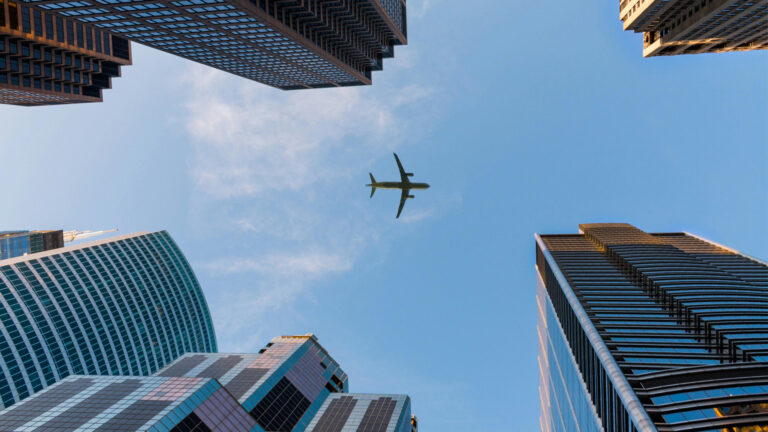 An airplane above buildings