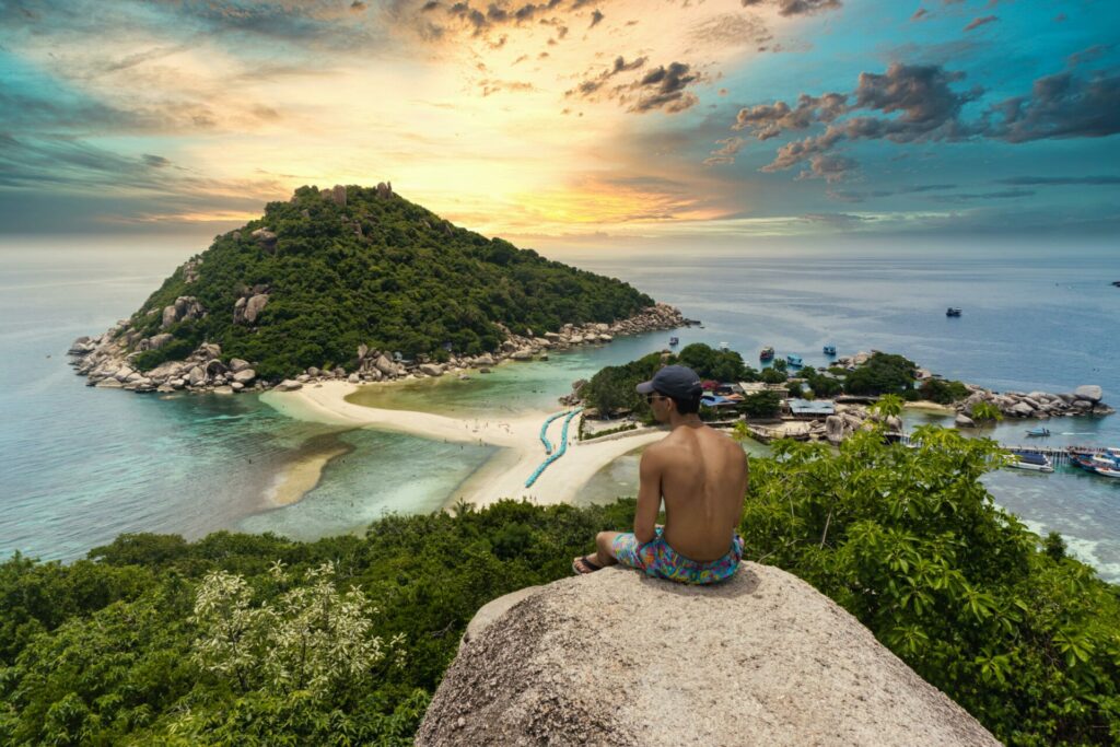 Man looking on to a magnificent scene of Thailand coastline